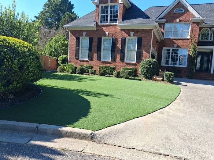 Artificial turf installation at a brick home